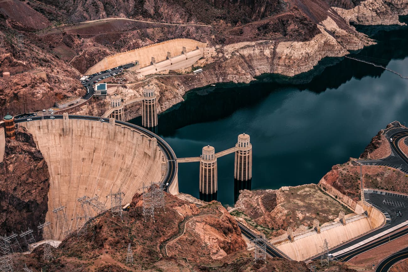 High-angle view of the Hoover Dam and the dark blue water of Lake Mead.