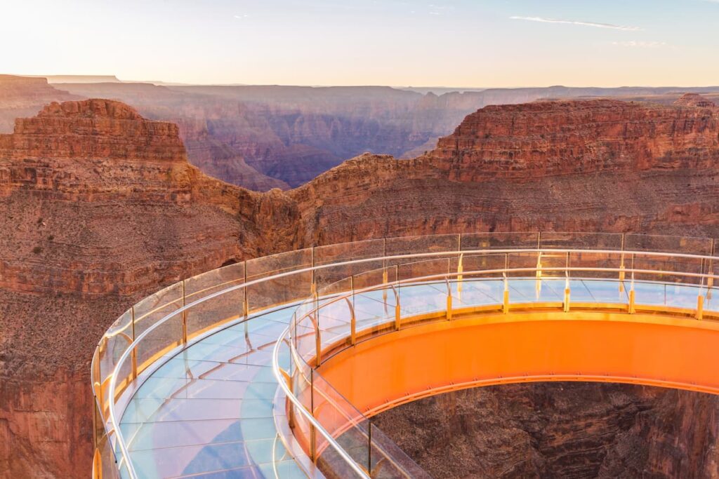 Glass horseshoe-shaped Grand Canyon Skywalk extending over a red-rock canyon.